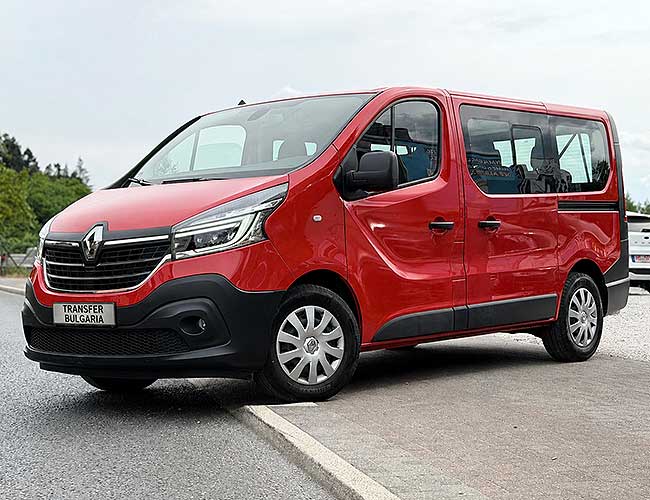 Red Renault Trafic minibus, front three-quarter view, parked roadside with Transfer Bulgaria plate