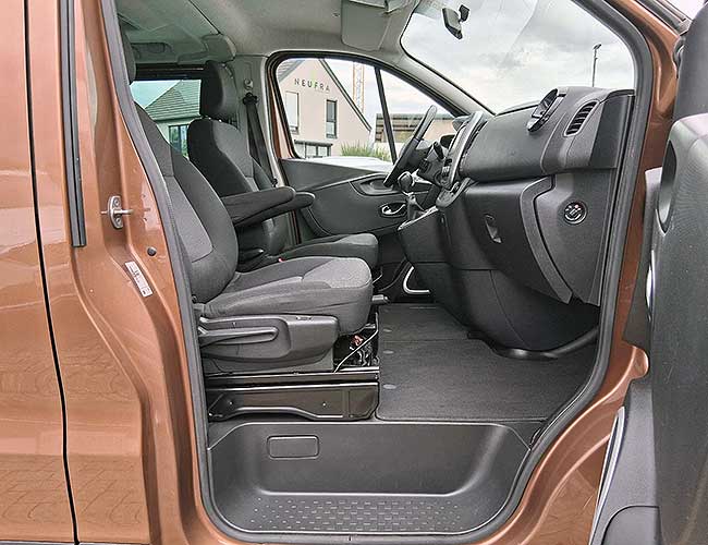 Driver's cabin and front seats of the bronze Renault Trafic with the door open