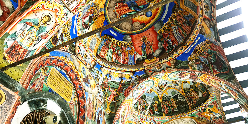 The striped arches and main church courtyard of Rila Monastery in the Rila Mountains